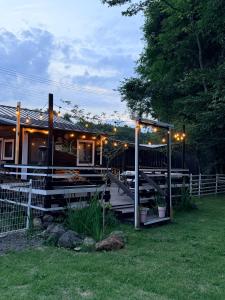 a house with a deck with lights on it at Foresta Karuizawa 7 Glamping & camping for 8 people in Naganohara