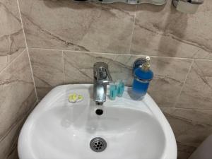 a white sink in a bathroom with a cup on it at Guest House on Rustaveli 176 in Kobuleti +63 photos