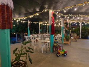 a patio with a tent with lights and a toy at Yaxlik River Lodge in Lanquín