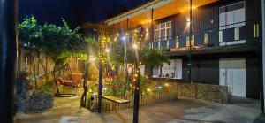 a courtyard of a building at night with lights at Guesthouse Turo in Ambrolauri