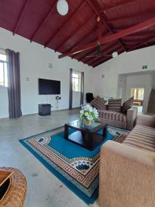 a living room with a couch and a coffee table at Villa Idda in Padukka