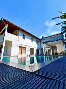 a building with a swimming pool in front of it at Villa Idda in Padukka