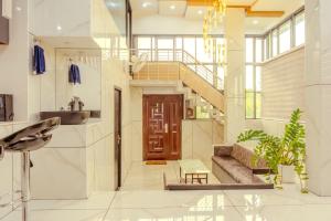 a living room with a staircase and a sink at E7 Apartment in Bekal