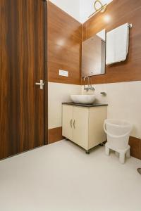 a bathroom with a sink and a mirror at Doon Nature Valley Resort, Mussoorie in Mussoorie +54 photos