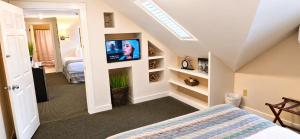 a bedroom with a bed and a tv in a room at Pilgrim House in Provincetown