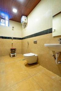 a bathroom with a toilet and a sink at SREE Kumaran Residence in Rāmeswaram