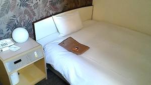 Una cama o camas en una habitación de Heal In Yokkaichi