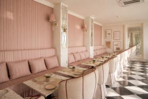 a long dining room with a long table and chairs at Raj Kuber - A Boutique Lake View Hotel in Udaipur