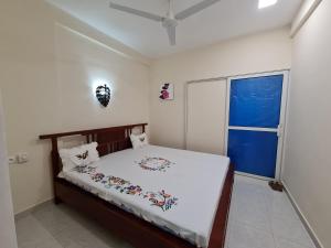 a bedroom with a bed and a window at BazarBe Appartment in Nosy Be
