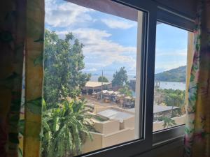 a window with a view of a town at BazarBe Appartment in Nosy Be