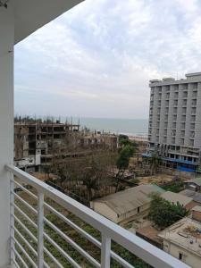 a view of the ocean from a balcony of a building at Falcon Beach Resort in Cox's Bazar