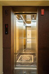 an elevator in a building with the door open at SREE Kumaran Residence in Rāmeswaram +25 photos