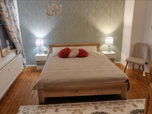 ein Schlafzimmer mit einem Bett, auf dem zwei rote Kissen liegen in der Unterkunft SollingNest in Uslar