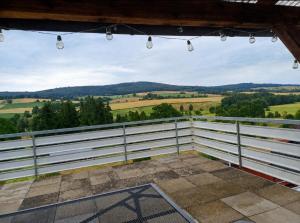 Blick vom Balkon eines Hauses mit weißem Zaun in der Unterkunft SollingNest in Uslar