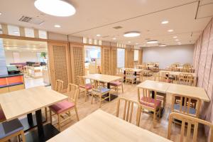 an empty restaurant with tables and chairs at Hotel Hokke Club Hiroshima in Hiroshima