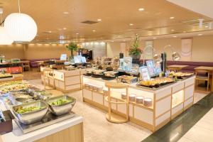 a buffet line with food on display in a restaurant at Hotel Hokke Club Hiroshima in Hiroshima +42 photos