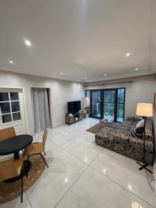 a living room with a couch and a table at KameronStudio in Yaoundé