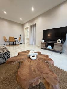 a living room with a table in the middle at KameronStudio in Yaoundé +4 photos