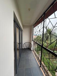 a balcony with a bench and a large window at KameronStudio in Yaoundé