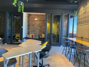a restaurant with tables and stools in a room at depa en el centro con estacionamiento in Monterrey