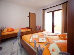 Postel nebo postele na pokoji v ubytování Apartments Dario