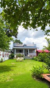 a house with a grass yard with a building at Kudrat Villa with Private Pool in Dehradun +6 photos