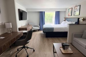 a hotel room with a bed and a desk at Wingate by Wyndham Athens GA in Athens