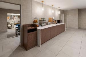 a kitchen with a counter and a dining room at La Quinta by Wyndham Ruidoso Downs in Ruidoso Downs