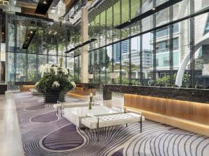 a lobby with a couch and a table in a building at Hotel Indonesia Kempinski Jakarta in Jakarta
