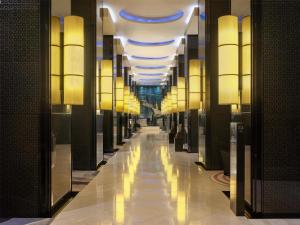 a hallway in a building with lights on the ceilings at Hotel Indonesia Kempinski Jakarta in Jakarta