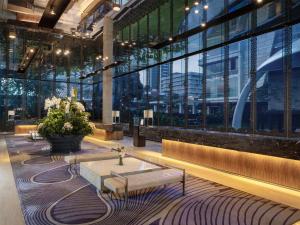 a lobby with a couch and a table in a building at Hotel Indonesia Kempinski Jakarta in Jakarta +91 photos