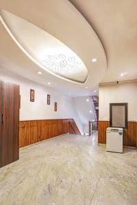 a large room with a ceiling with a television in it at Hotel Sai Deluxe in New Delhi