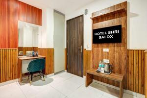 a room with a desk and a sign that reads hotel stick saltay at Hotel Sai Deluxe in New Delhi
