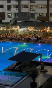 a large swimming pool with people in a building at Andra Rezidence in Popeşti-Leordeni
