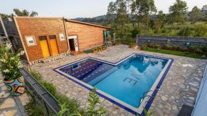 a swimming pool in a yard next to a house at JET VILLAS ENTEBBE ( JVE ) in Entebbe