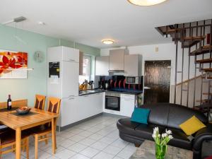 a kitchen and living room with a couch and a table at Carmen u. Rudolf Lutz in Norddeich