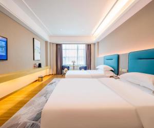 a hotel room with two beds and a window at Cheermay Hotels in Dongguan +285 photos