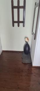 a room with a black vase with a plant in it at View By the Castle Nafpaktos in Nafpaktos