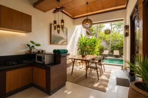a kitchen and dining room with a table and chairs at Bali Ayu Hotel & Villas 10 Minutes Walking Distance to the Beach in Seminyak