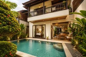 an image of a swimming pool in front of a house at Bali Ayu Hotel & Villas 10 Minutes Walking Distance to the Beach in Seminyak