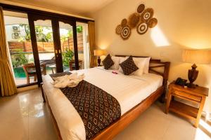 a bedroom with a large bed in a room at Bali Ayu Hotel & Villas 10 Minutes Walking Distance to the Beach in Seminyak +46 photos