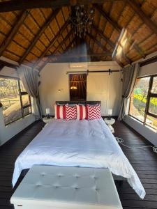 a bedroom with a large bed with red and white pillows at The Blue Gum Collection in Midrand