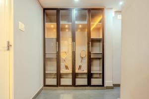 a glass display case with tennis rackets in it at E7 Apartment in Bekal +104 photos