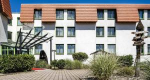 a large white building with a red roof at Best Western Spreewald in Lübbenau