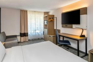 a hotel room with a bed and a desk at Comfort Inn in North Bay