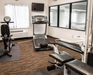 a room with a gym with a treadmill and a mirror at Sleep Inn & Suites Monticello in Charlottesville