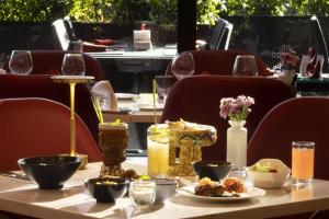 a table with food and wine glasses on it at Kempinski Hotel Beijing Yansha Center in Beijing