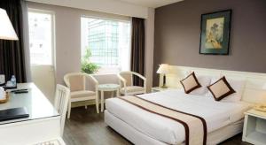 a hotel room with a large white bed and a desk at Saigon Star Hotel in Ho Chi Minh City +108 photos