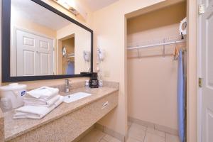 a bathroom with a sink and a mirror at Quality Inn & Suites Williamsport in Williamsport +22 photos