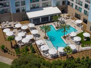 an overhead view of a pool at a hotel with umbrellas at Hyatt House Destin in Destin